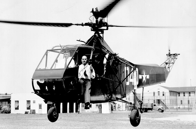 The R-4 is evaluated by the US Coast Guard, with Igor Sikorsky seated in the hoist sling.